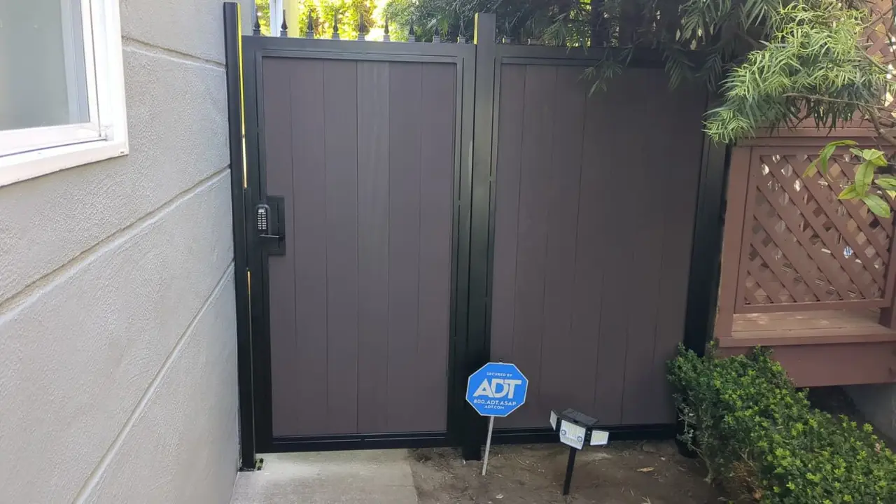 Steel-framed composite side gate with a mechanical keypad lock