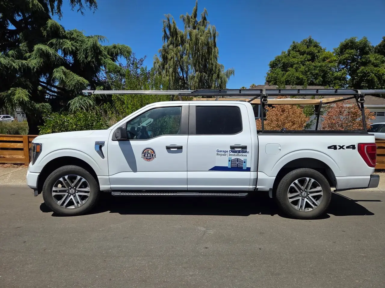 Our service truck with a ladder rack loaded with gate materials